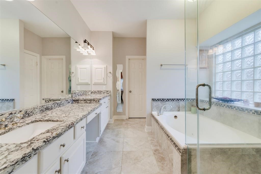 14103 Heatherhill Place Houston, TX 77077 - Photo 23 of 47 a bathroom with a granite countertop tub sink and mirror