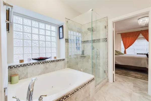 a bathroom with a tub and a shower