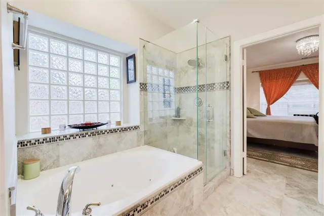 a bathroom with a tub and a shower
