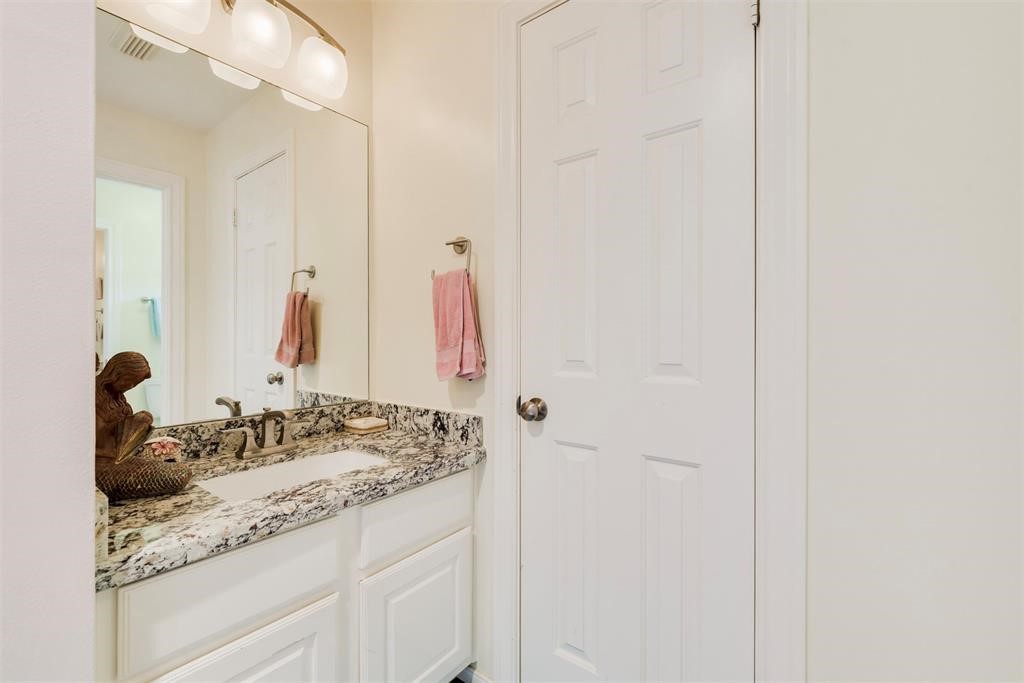 14103 Heatherhill Place Houston, TX 77077 - Photo 30 of 47 a bathroom with a granite countertop sink and a mirror