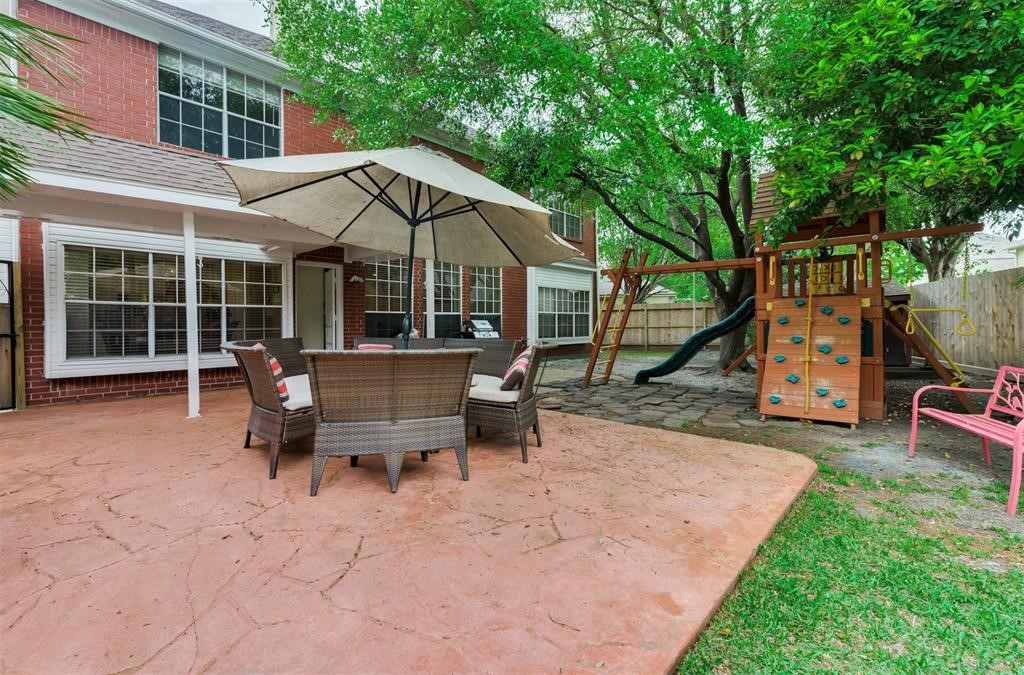 14103 Heatherhill Place Houston, TX 77077 - Photo 38 of 47 a view of a house with backyard and sitting area