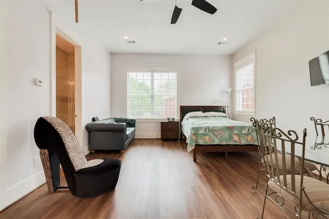 a bedroom with furniture and a large window
