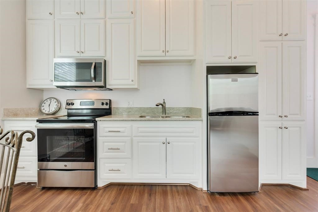 14103 Heatherhill Place Houston, TX 77077 - Photo 45 of 47 a kitchen with stainless steel appliances granite countertop a refrigerator stove and white cabinets