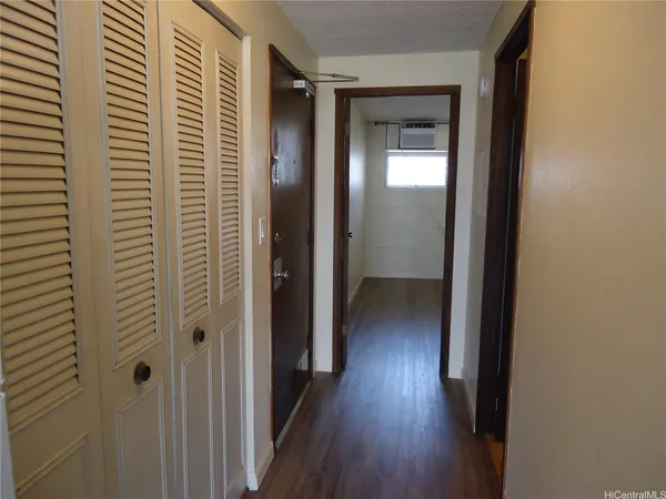 a view of a hallway with wooden floor