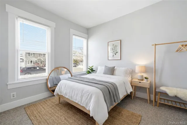 a bedroom with a bed wooden floor and a window