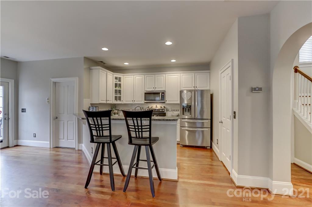 1178 Market Street Fort Mill, SC 29708 - Photo 13 of 47 a kitchen with stainless steel appliances kitchen island granite countertop a dining table chairs and refrigerator