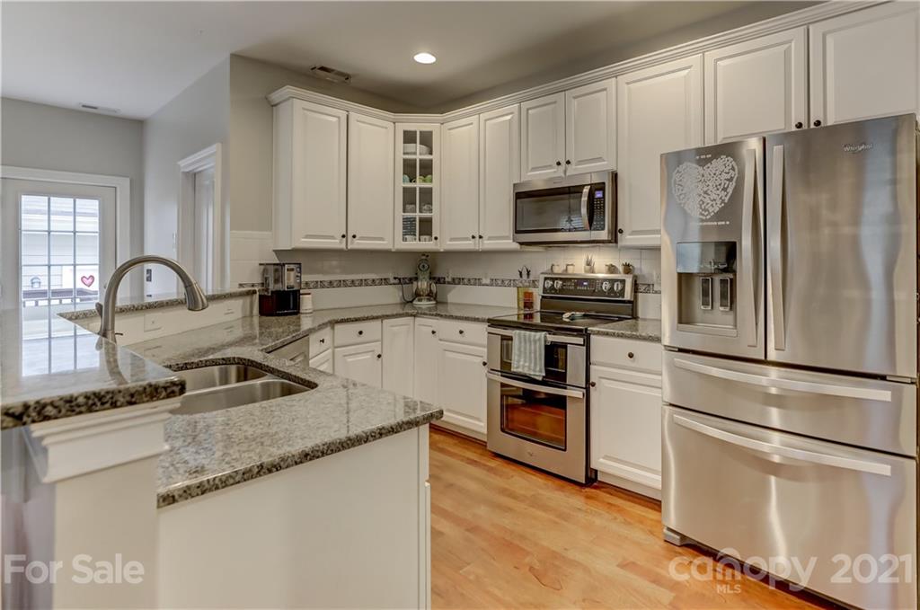 1178 Market Street Fort Mill, SC 29708 - Photo 14 of 47 a kitchen with stainless steel appliances granite countertop a refrigerator stove a sink and white cabinets