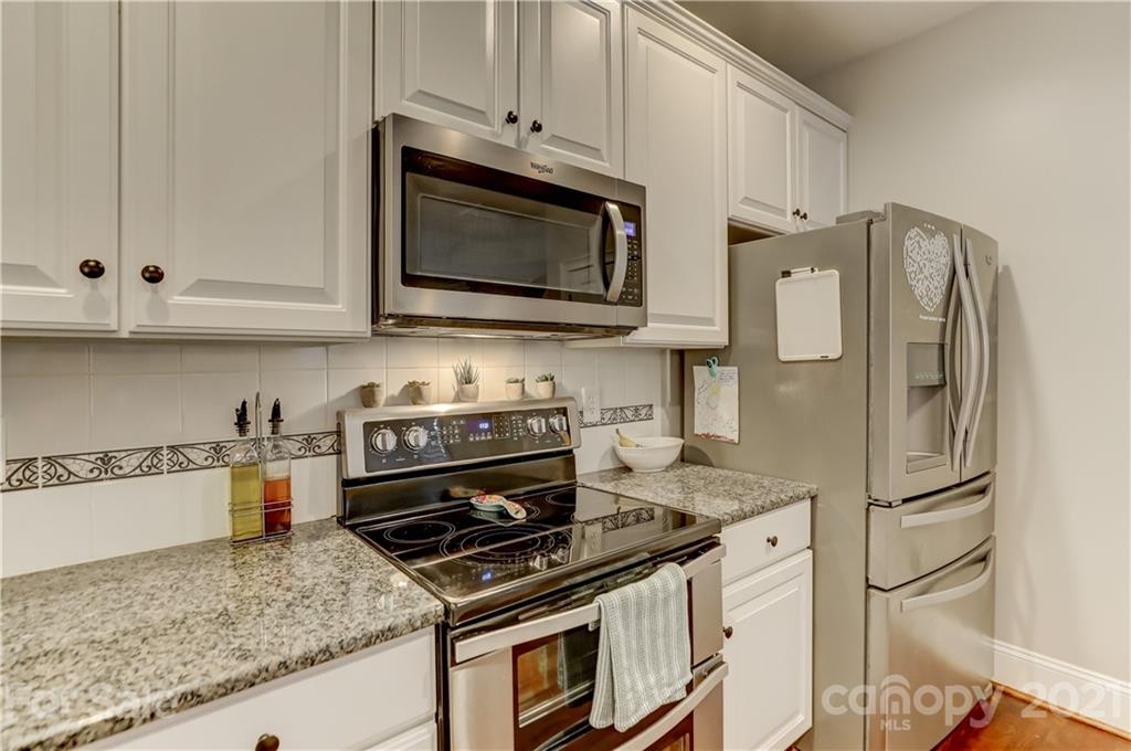 1178 Market Street Fort Mill, SC 29708 - Photo 16 of 47 a kitchen with stainless steel appliances granite countertop a stove microwave and refrigerator