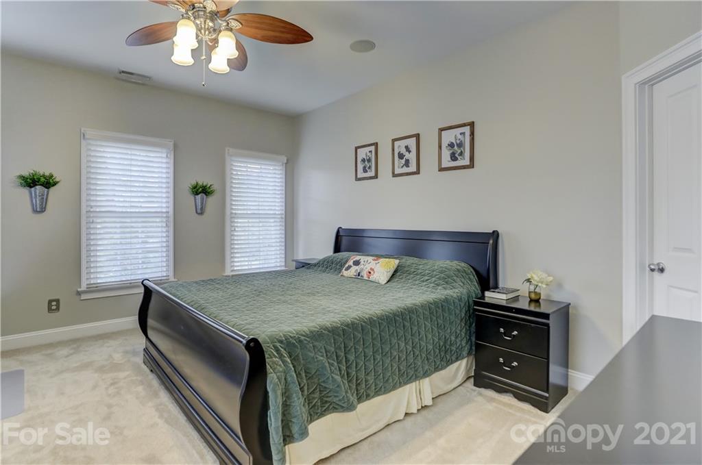1178 Market Street Fort Mill, SC 29708 - Photo 26 of 47 a bedroom with a bed and a chandelier