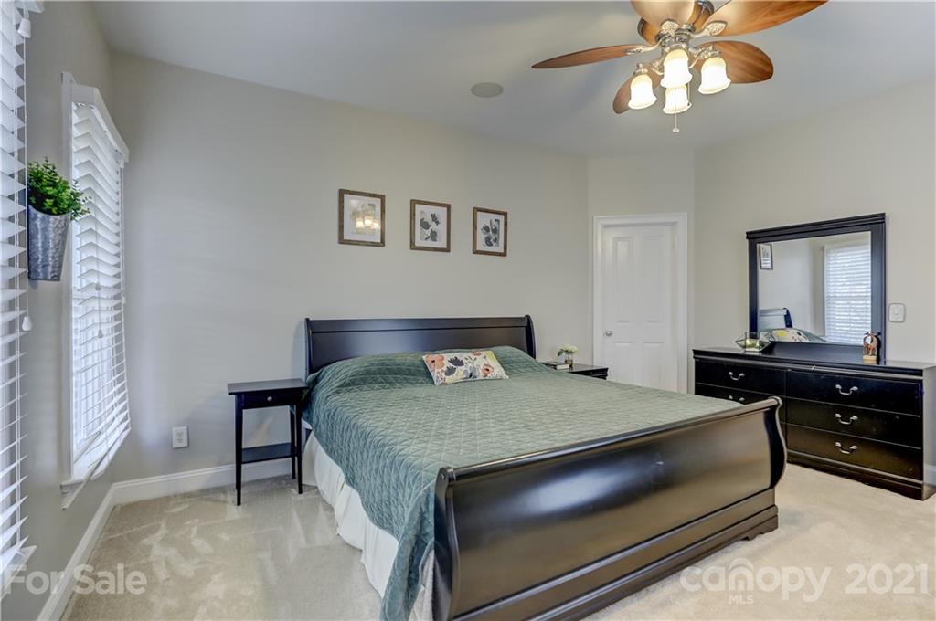 1178 Market Street Fort Mill, SC 29708 - Photo 27 of 47 a bedroom with a bed and a chandelier