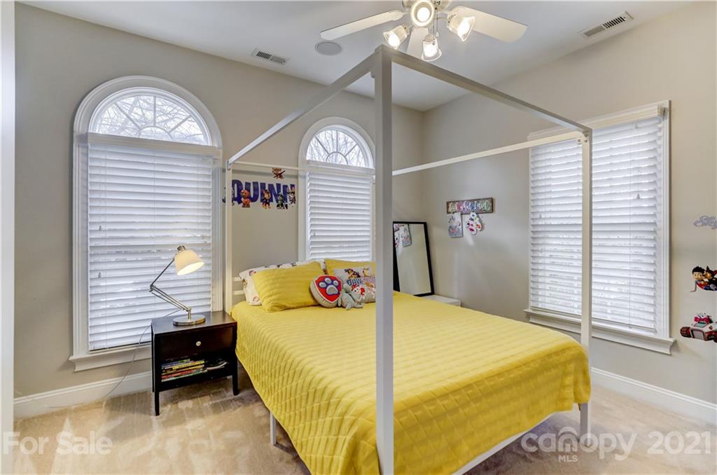 1178 Market Street Fort Mill, SC 29708 - Photo 38 of 47 a bedroom with a bed and a chandelier