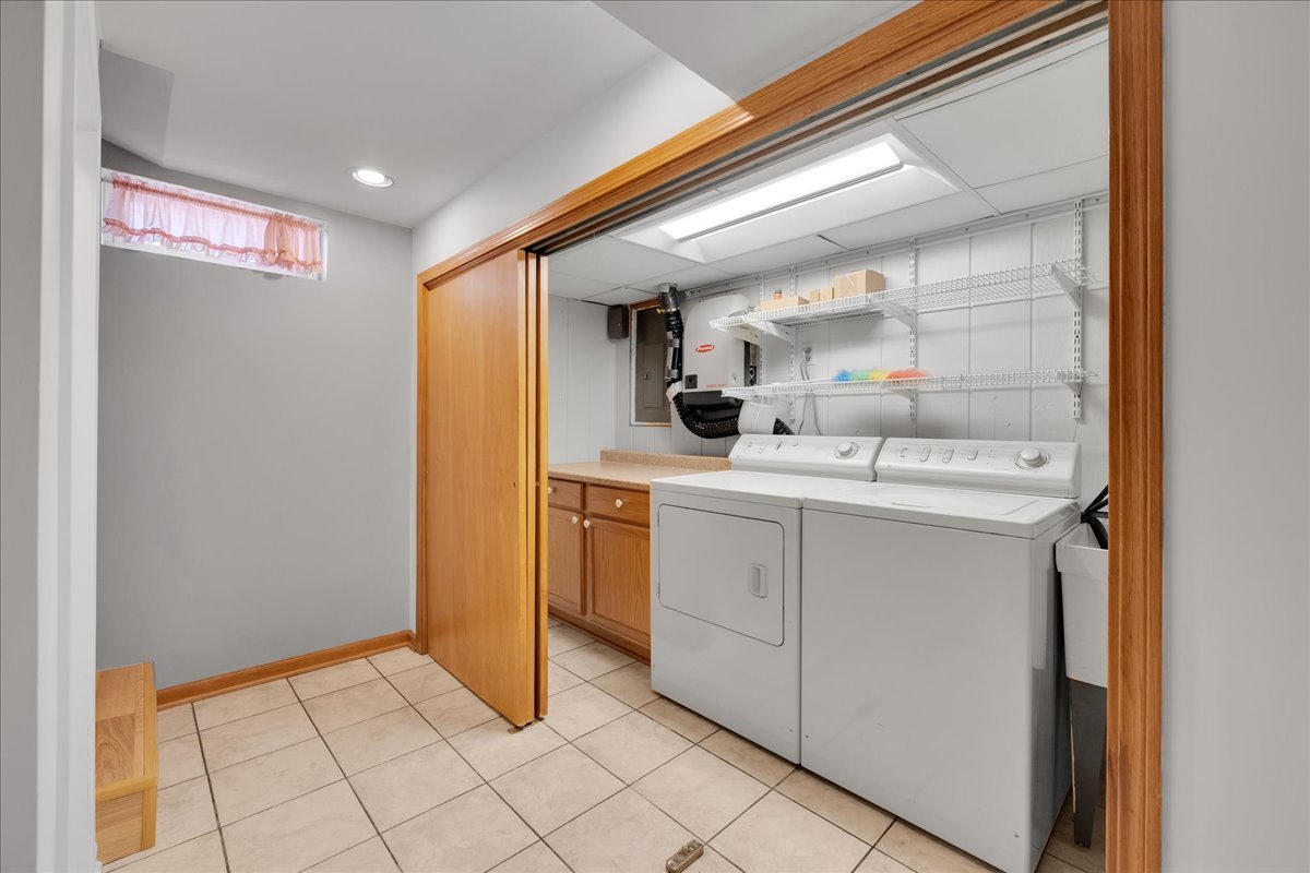 1427 Busse Road Mount Prospect, IL 60056 - Photo 14 of 38 a kitchen with a sink and cabinets