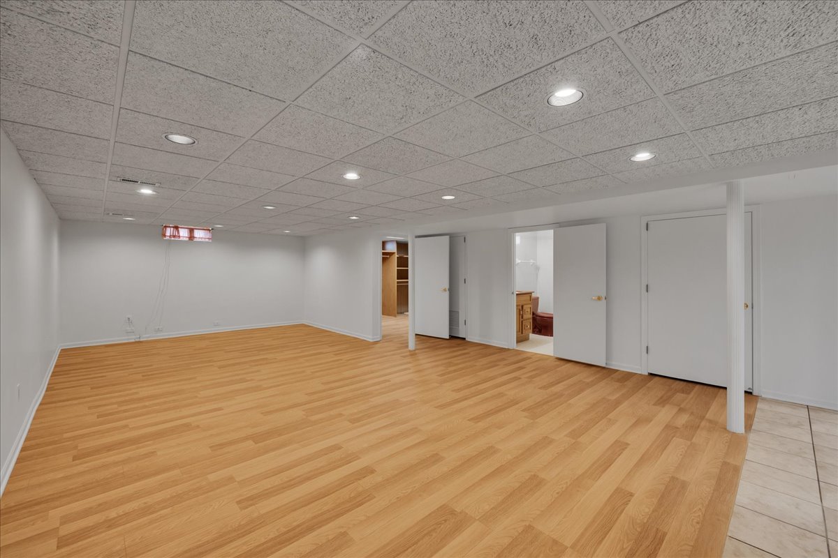 1427 Busse Road Mount Prospect, IL 60056 - Photo 17 of 38 a view of an empty room with wooden floor