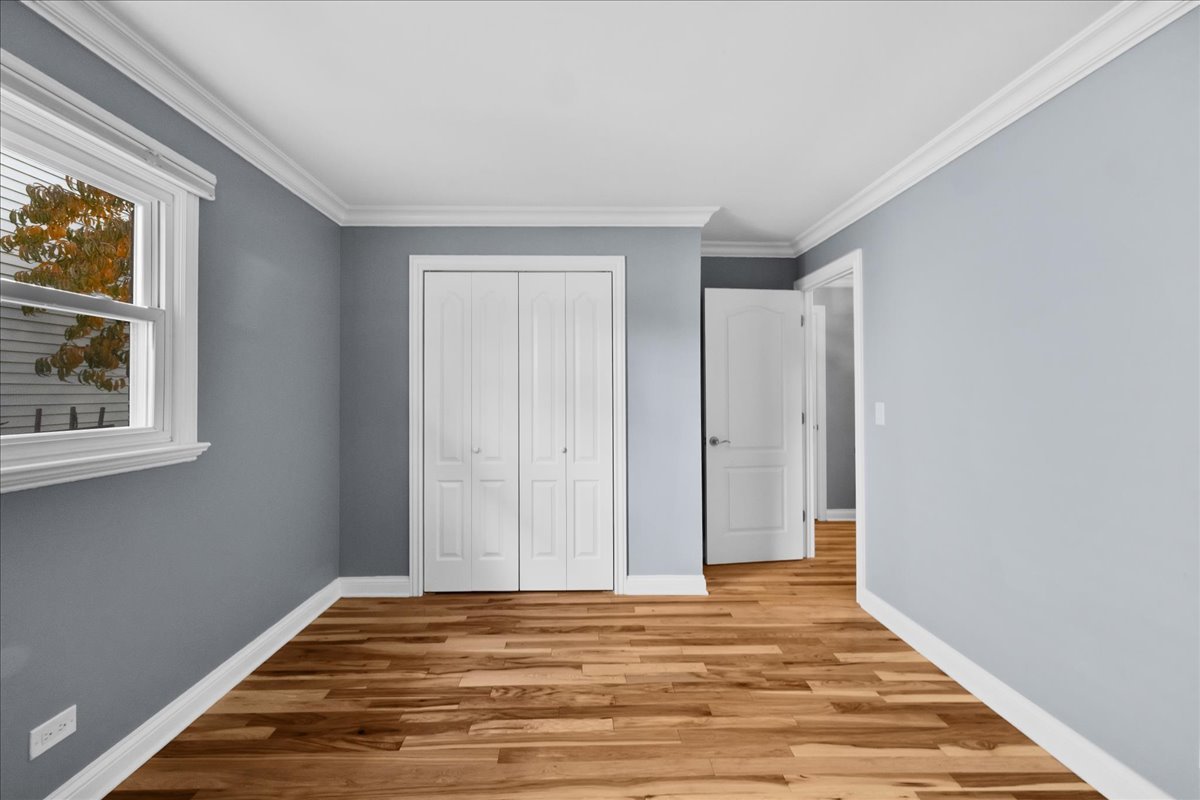 1427 Busse Road Mount Prospect, IL 60056 - Photo 23 of 38 a view of a room with wooden floor and windows