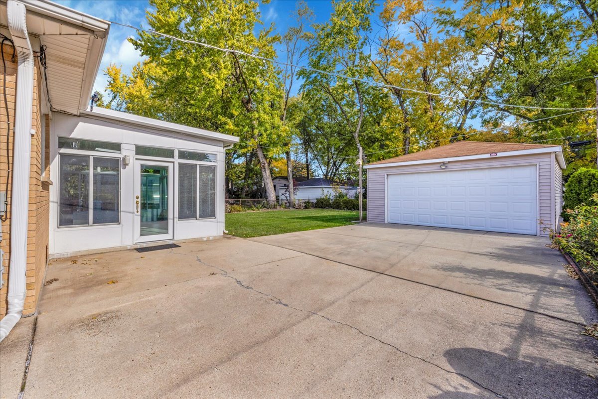 1427 Busse Road Mount Prospect, IL 60056 - Photo 34 of 38 front view of a house with a yard and an trees