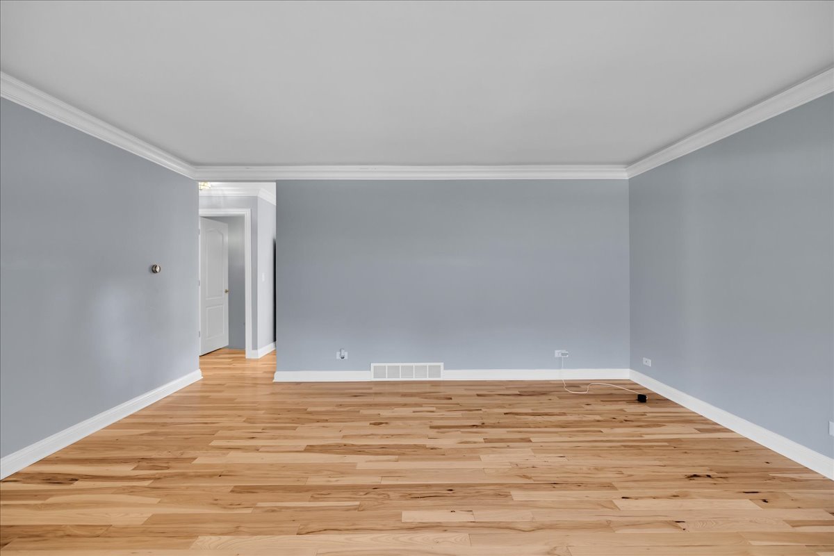 1427 Busse Road Mount Prospect, IL 60056 - Photo 6 of 38 a view of an empty room with wooden floor