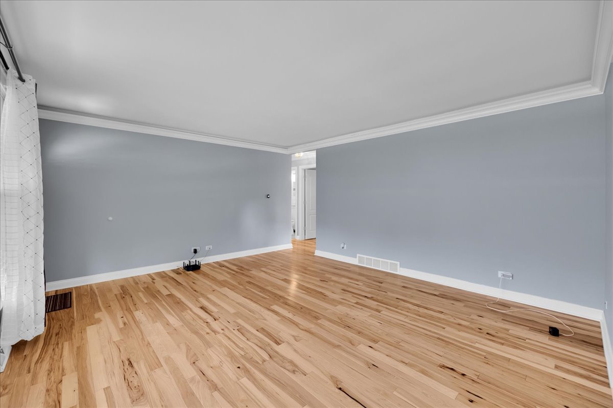 1427 Busse Road Mount Prospect, IL 60056 - Photo 7 of 38 a view of an empty room with wooden floor