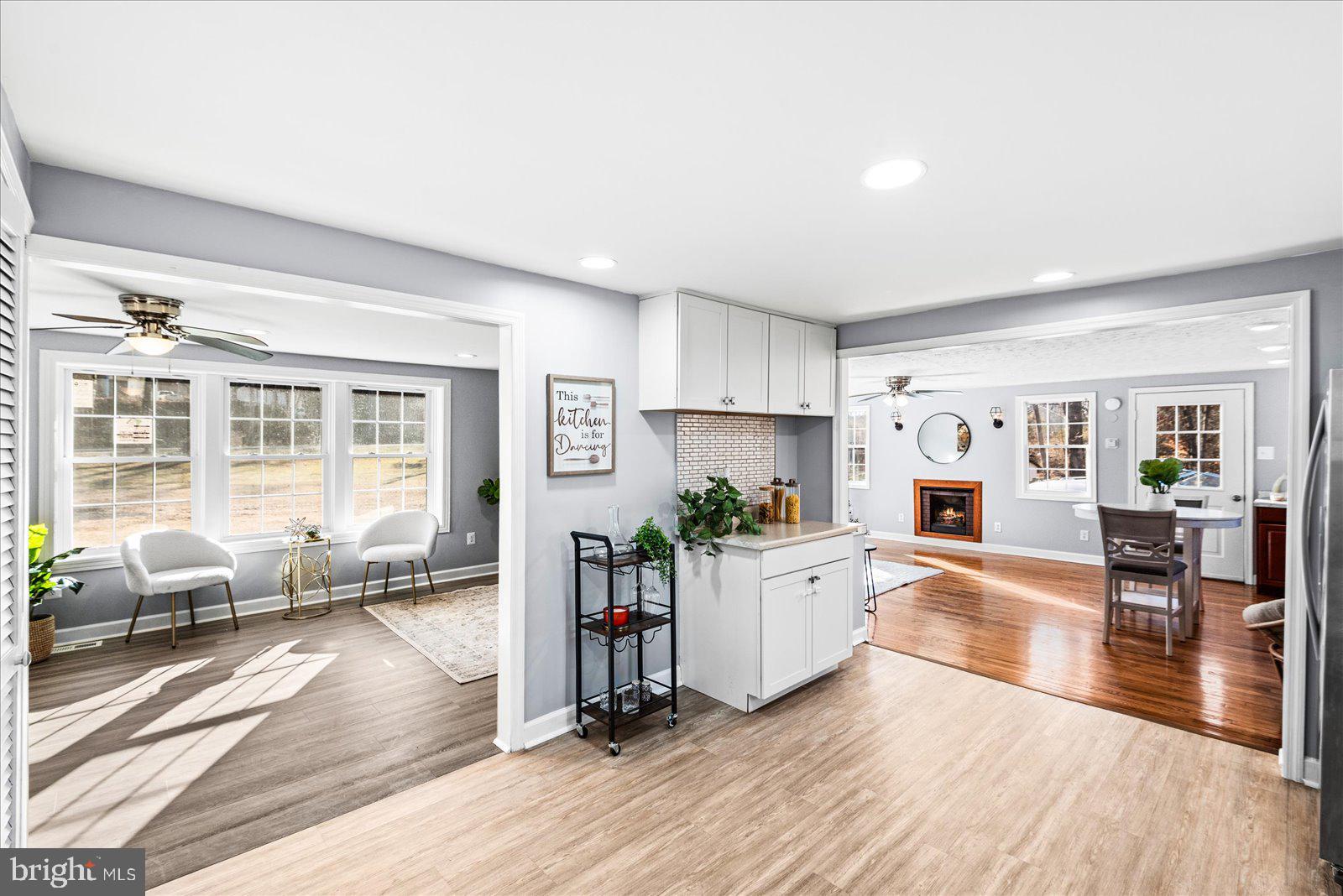 27 Truslow Road Fredericksburg, VA 22405 - Photo 12 of 35 a living room with fireplace furniture wooden floor and a large window