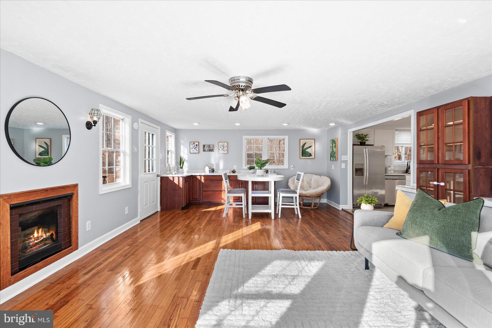 27 Truslow Road Fredericksburg, VA 22405 - Photo 16 of 35 a living room with furniture a clock and a fireplace