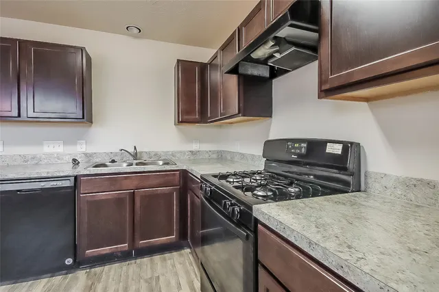 a kitchen with stainless steel appliances granite countertop a stove and a sink