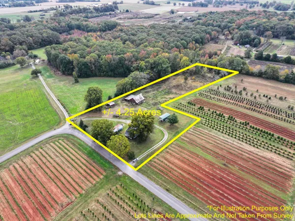 a view of a pool with a bench and lawn chairs