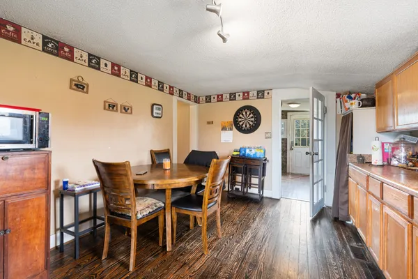 a view of a dining room with furniture and wooden floor