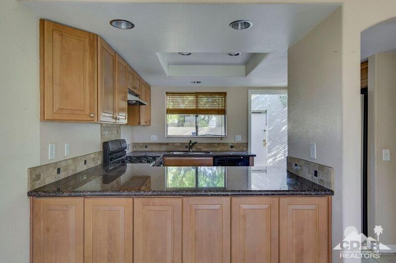 34404 Laura Way Rancho Mirage, CA 92270 - Photo 11 of 31 a kitchen with sink a microwave and cabinets