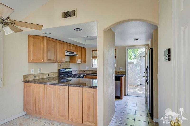 34404 Laura Way Rancho Mirage, CA 92270 - Photo 12 of 31 a kitchen with stainless steel appliances granite countertop a refrigerator and a sink