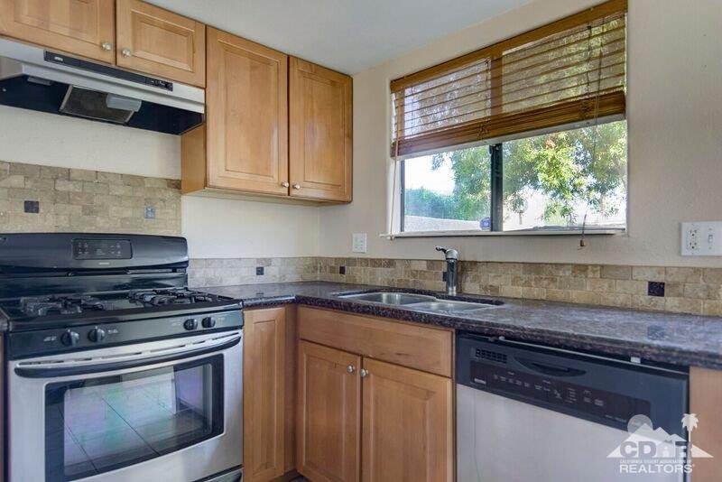 34404 Laura Way Rancho Mirage, CA 92270 - Photo 14 of 31 a kitchen with granite countertop a sink a stove and cabinets
