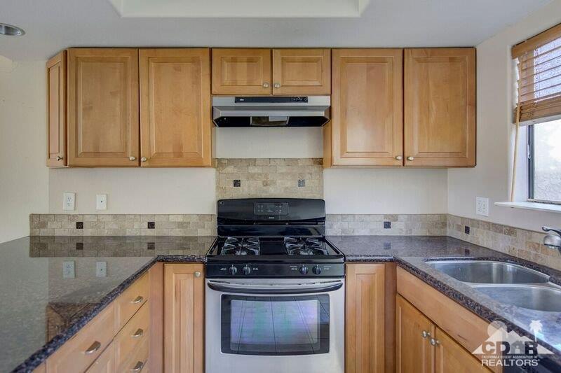 34404 Laura Way Rancho Mirage, CA 92270 - Photo 3 of 31 a kitchen with granite countertop a sink a stove and cabinets