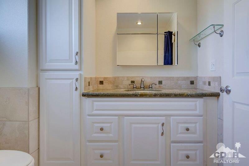 34404 Laura Way Rancho Mirage, CA 92270 - Photo 22 of 31 a bathroom with a granite countertop sink and a mirror