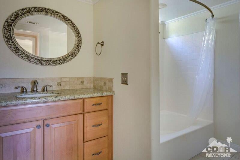 34404 Laura Way Rancho Mirage, CA 92270 - Photo 26 of 31 a bathroom with a granite countertop sink and a mirror