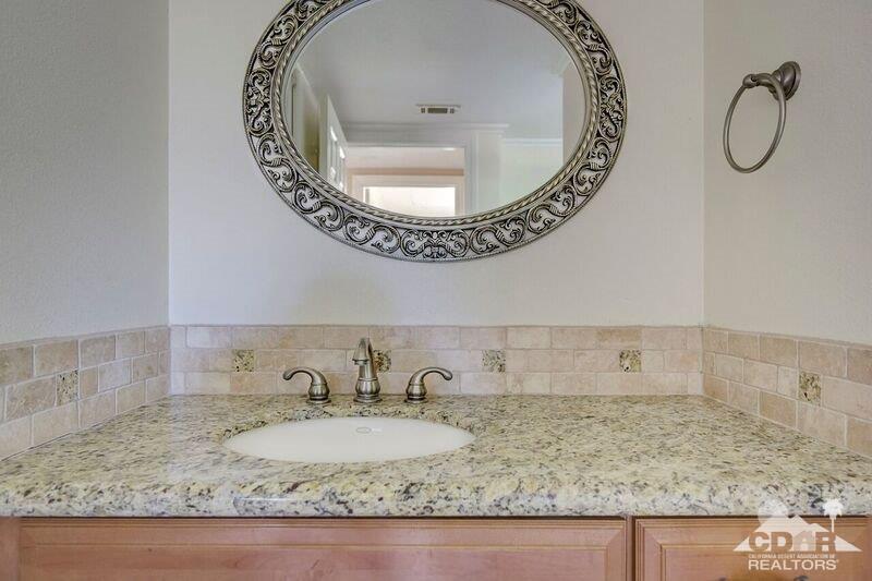 34404 Laura Way Rancho Mirage, CA 92270 - Photo 27 of 31 a bathroom with a granite countertop sink and mirror