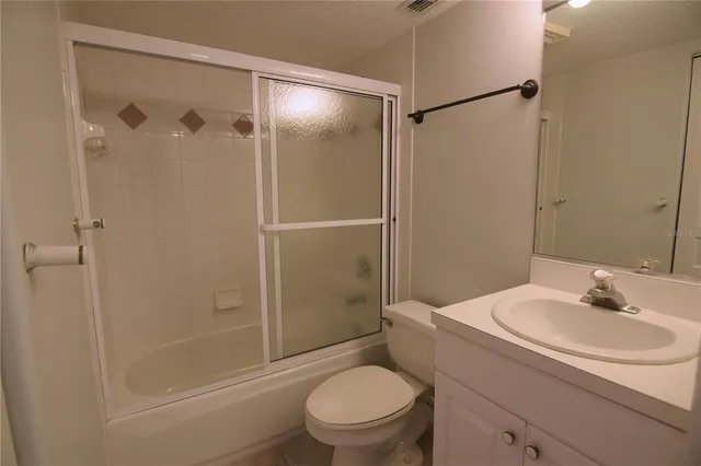 a bathroom with a shower a toilet and a sink