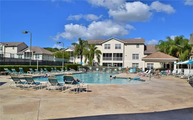 a view of a patio with swimming pool table and chairs