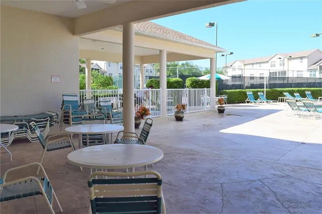 a view of a patio with a dining table and chairs