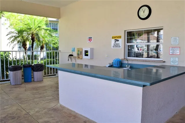 a kitchen with granite countertop a large window and a potted plant