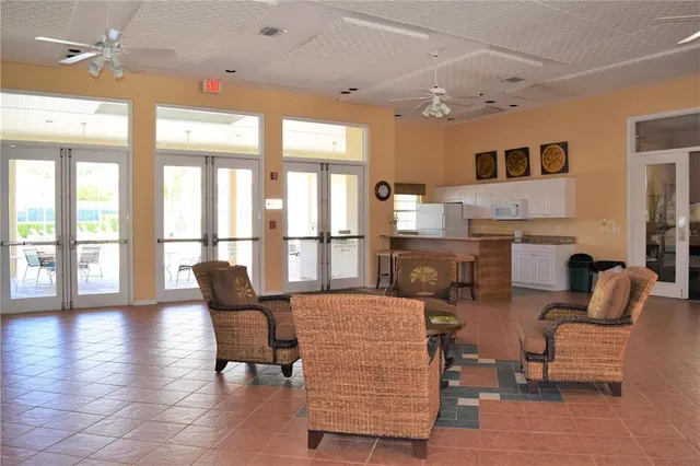 a living room with furniture and a floor to ceiling window