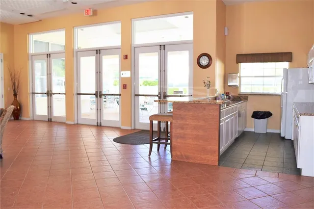 a very nice looking living room with a large window and wooden floor