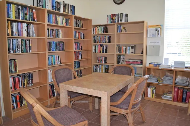 a view of a dining room with furniture and a book shelf