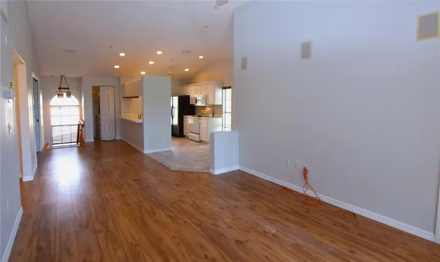 a view of a kitchen with wooden floor and a kitchen
