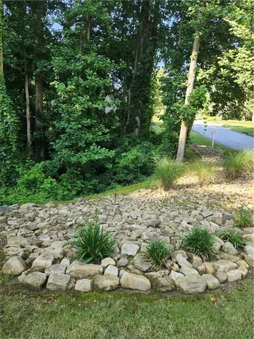 a kitchen with kitchen island granite countertop a sink and a stove