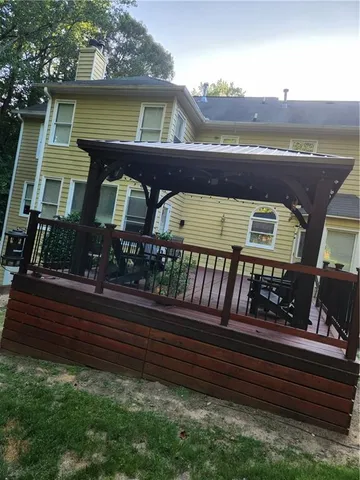 a view of a hallway with wooden floor and a potted plant