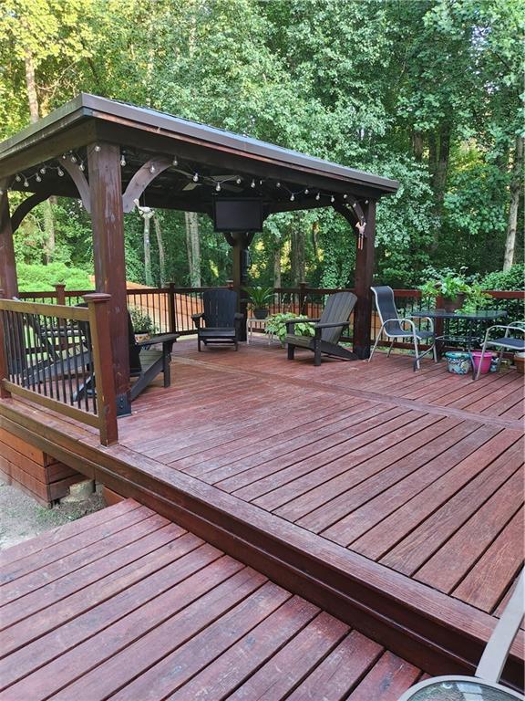 2520 Cobble Creek Lane Grayson, GA 30017 - Photo 33 of 114 a view of a deck with wooden floor barbeque oven and backyard