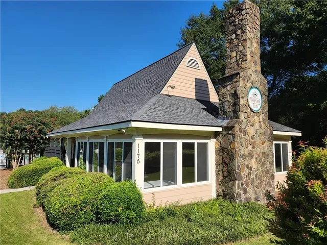 a backyard of a house with table and chairs