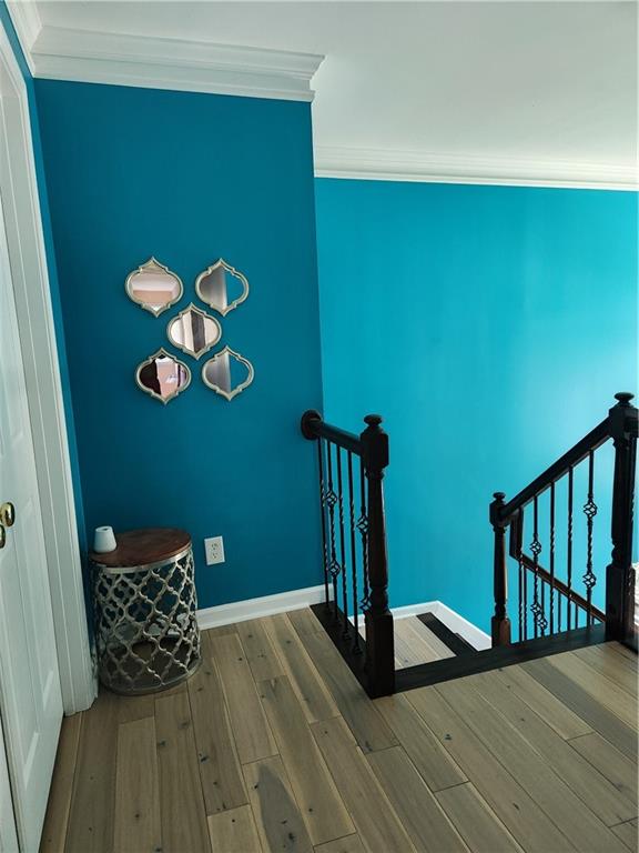 2520 Cobble Creek Lane Grayson, GA 30017 - Photo 71 of 114 a view of a hallway with wooden floor and a potted plant