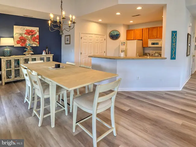 a living room with furniture and a dining table