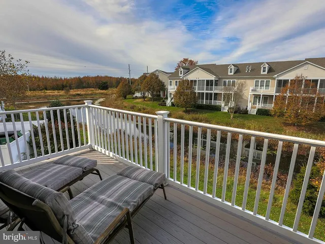a view of a living room filled with furniture and wooden floor