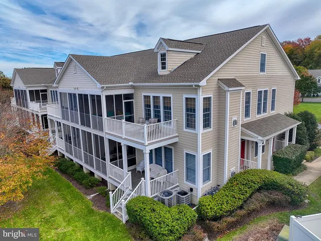 a bed sitting in a bedroom next to a window and a chandelier