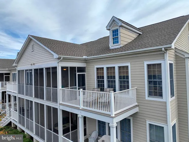 a large bed sitting in a bedroom next to a window